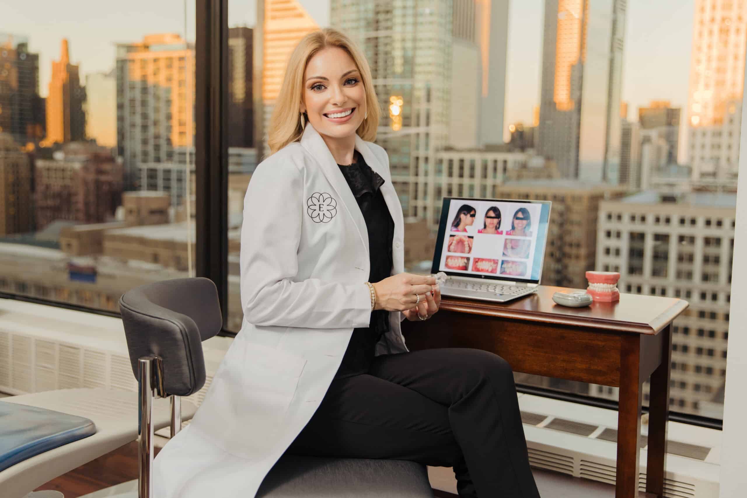 Board-certified orthodontist Dr. Emilia Taneva consulting with patients in Downtown Chicago Loop Orthodontic Office with city skyline view